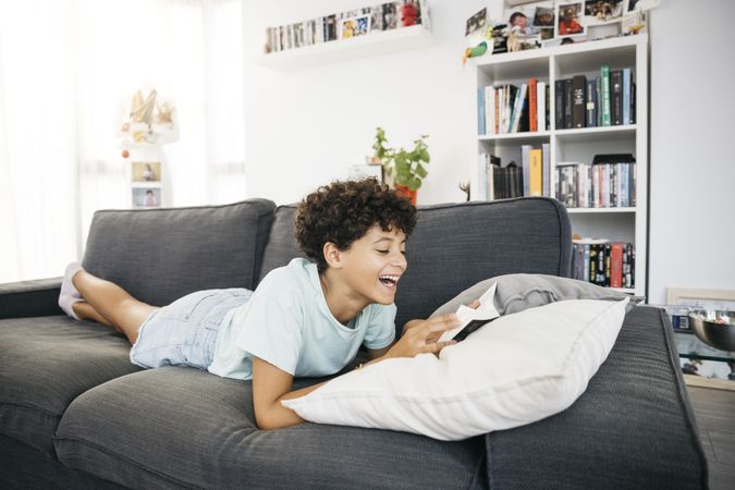 Girl reading a book on a sofa
