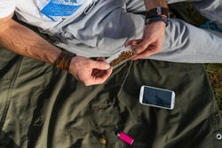 Man rolling a spliff outside