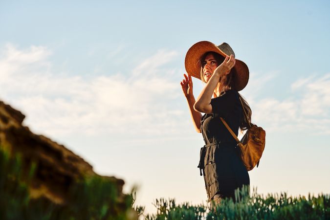 Woman traveler in straw hat walking