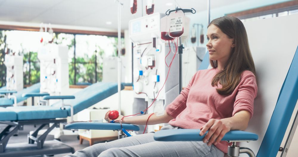 Woman Donating Blood For People In Need In Bright Hospital.