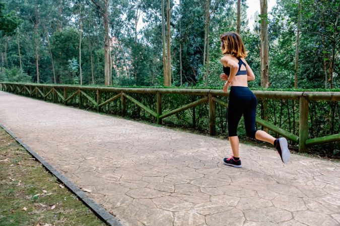 Woman running through a park