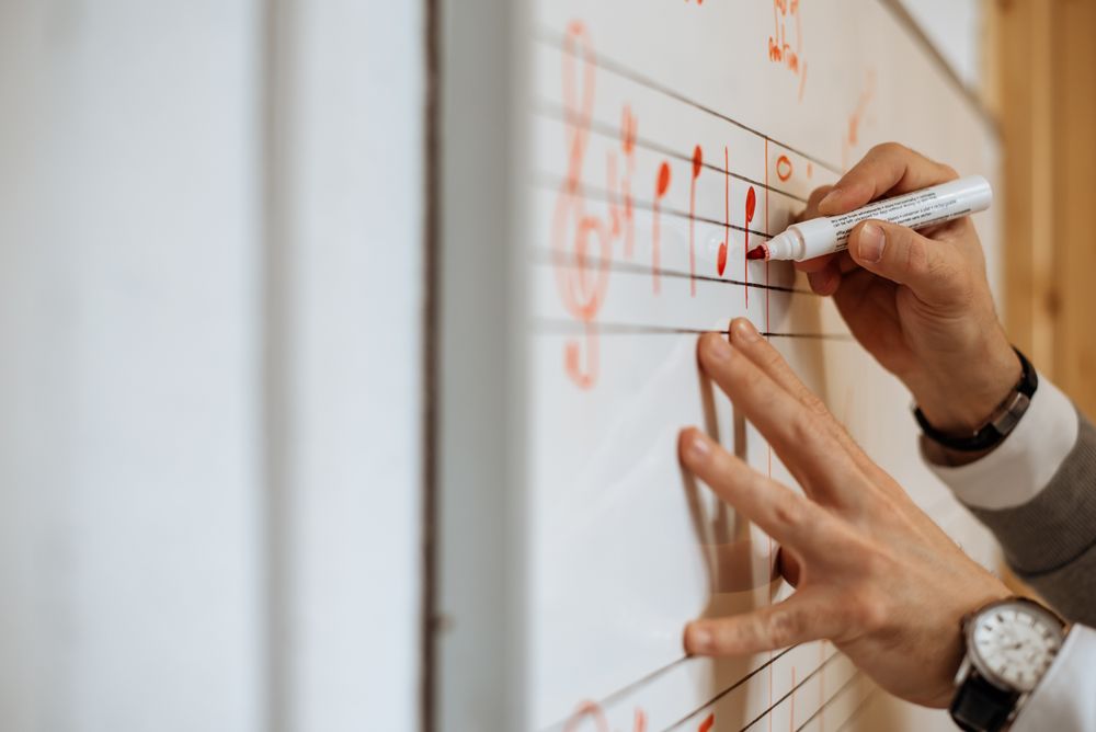 Man writing music notes