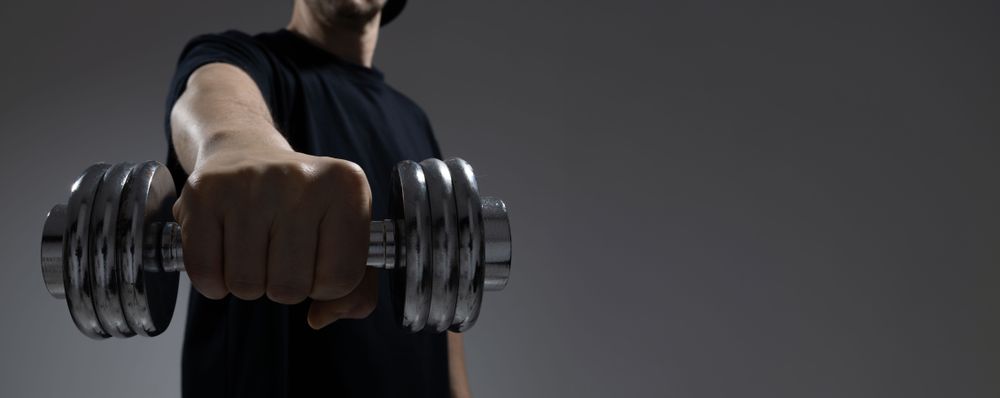 Man holding dumbbell from low angle