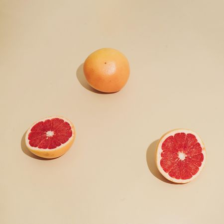 Grapefruit halfs on beige background