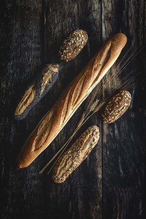 Assorted gold homemade bread on dark wood background