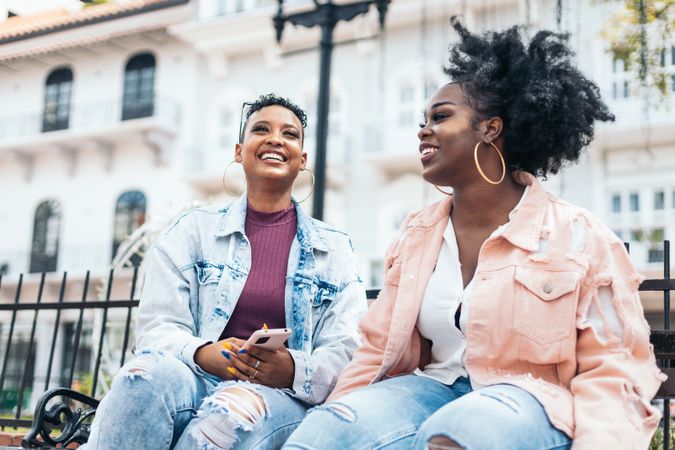 Black women talking and laughing in the city