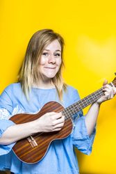Woman enjoying playing ukulele