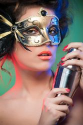 Woman in mask holding shaker