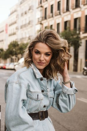 Stylish woman in middle of city road