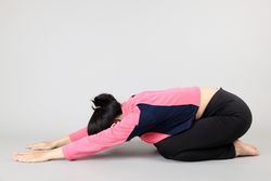 Young Woman doing Yoga Child Pose
