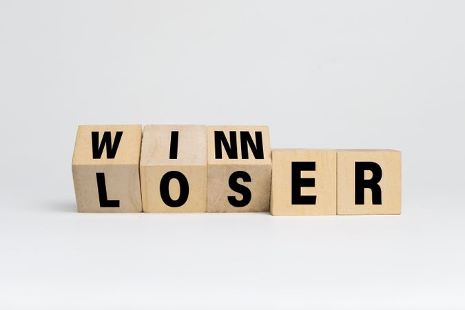flip wooden blocks with winner and loser words text isolated on light background. success or failure concept
