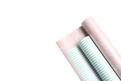 Rolls of festive wrapping paper on plain background. Space for text