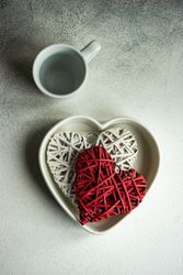 Top view of two heart ornaments in heart shape bowl