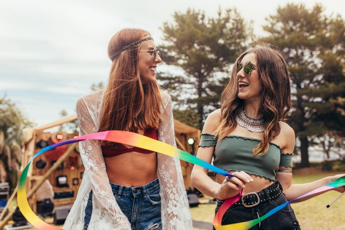 Hipsters with dancing ribbon wand at music festival