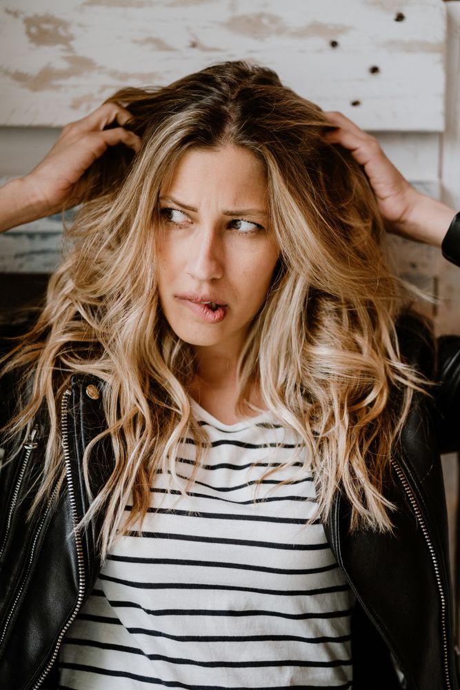 Woman clutching head and looking away