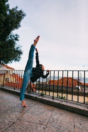 Female dancer dancing against cityscape