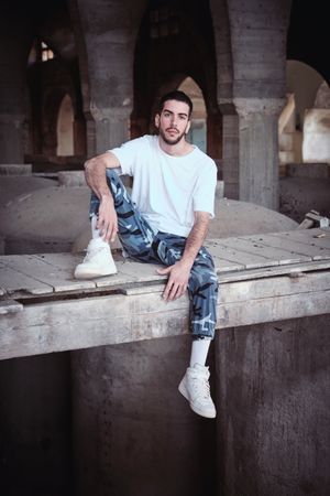 Confident man in neglected industrial facility