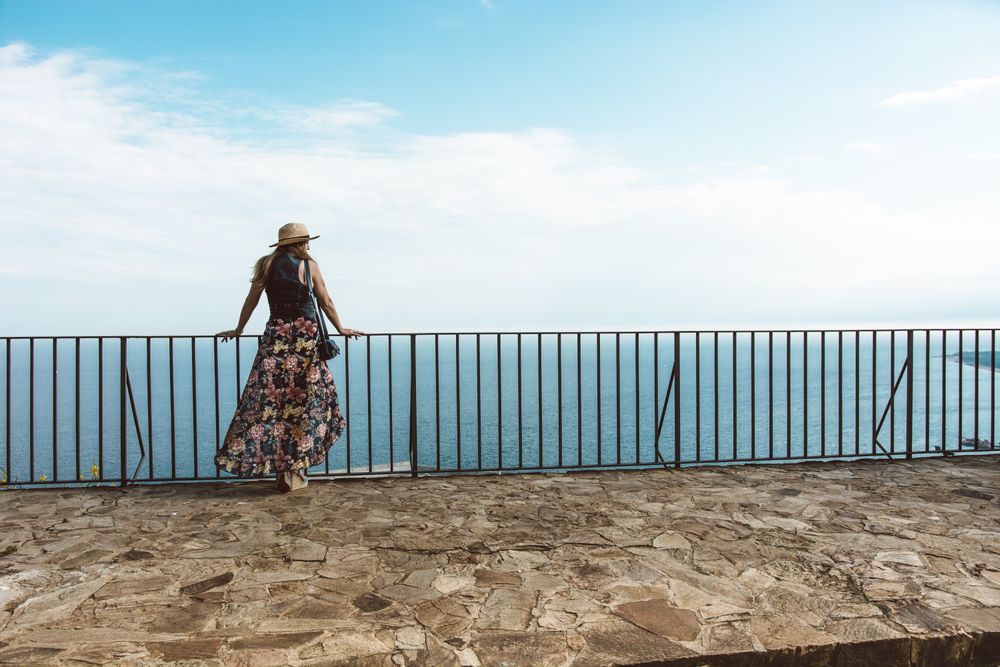 Stylish woman on terrace of seashore