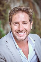 Handsome businessman in elegant suit smiling at camera
