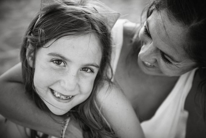 Woman with daughter on sunny beach