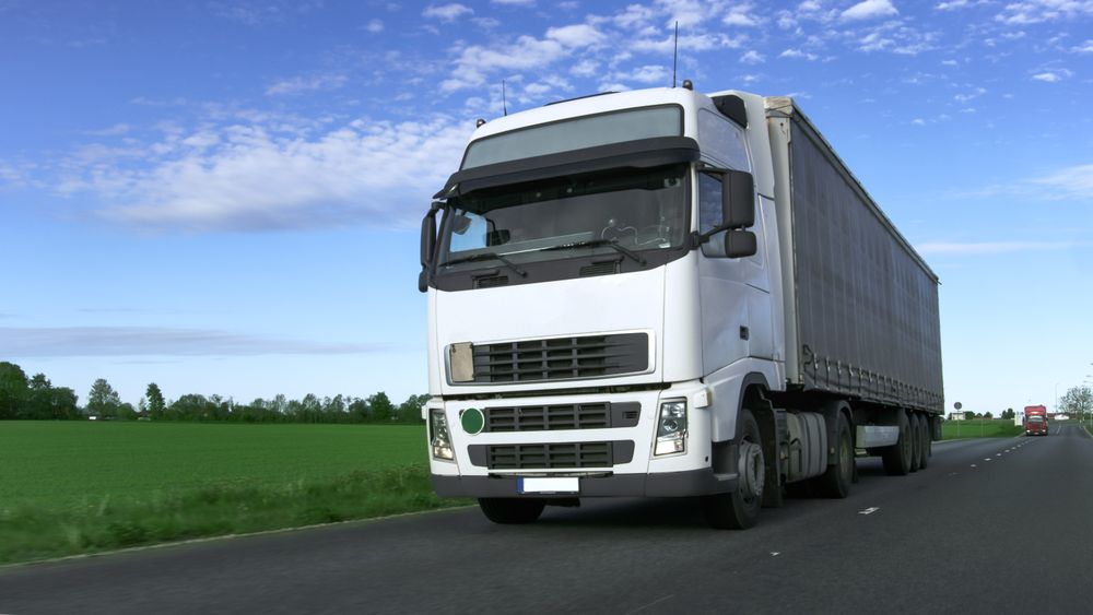 Truck with Semi Trailer Driving on the Rural Road.
