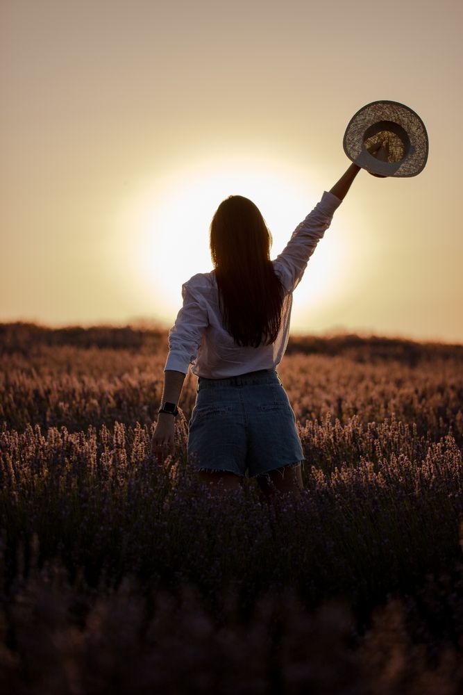 Anonymous woman walking in lavender field