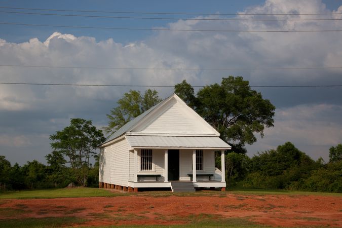 Cream rustic house with clouds in background in Alabama