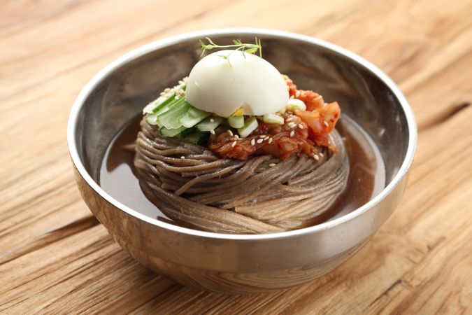 Korean Soba Noodle with Kimchi, Egg, and Cucumber Topping.