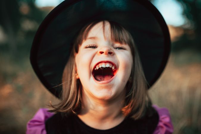 Girl laughing in witch costume