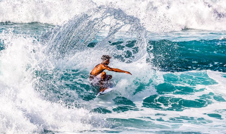 Man surfing on sea waves during daytime