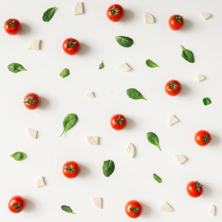 Basil, tomatoes, and cheese on light  background