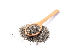 Chia seeds and wooden spoon isolated on blank background