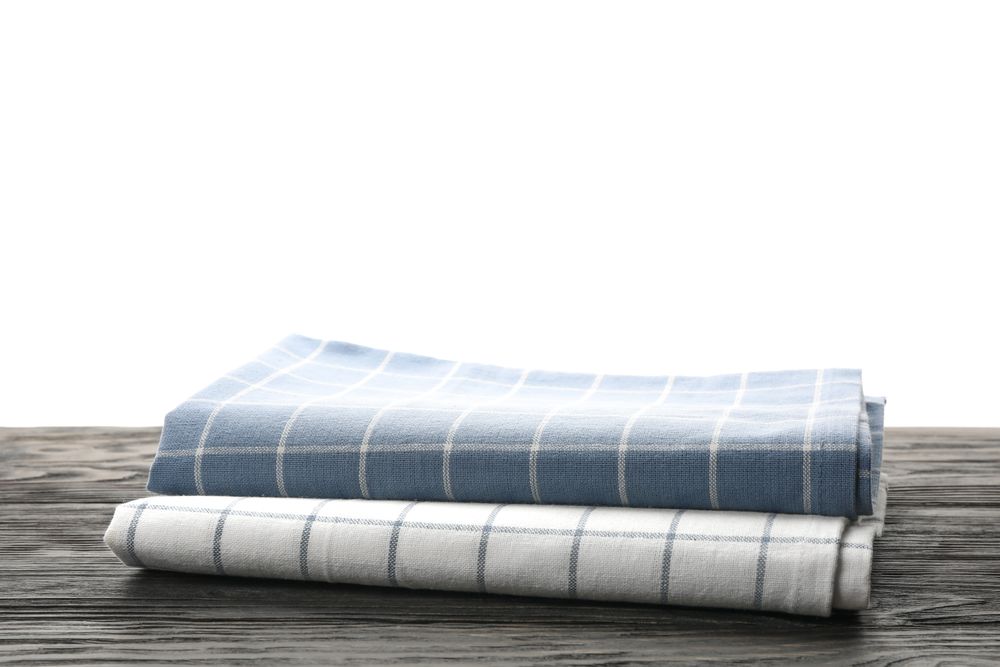 Fabric napkins on table against plain background, space for text