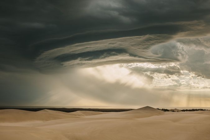 View of dramatic sky and sand dunes in desert