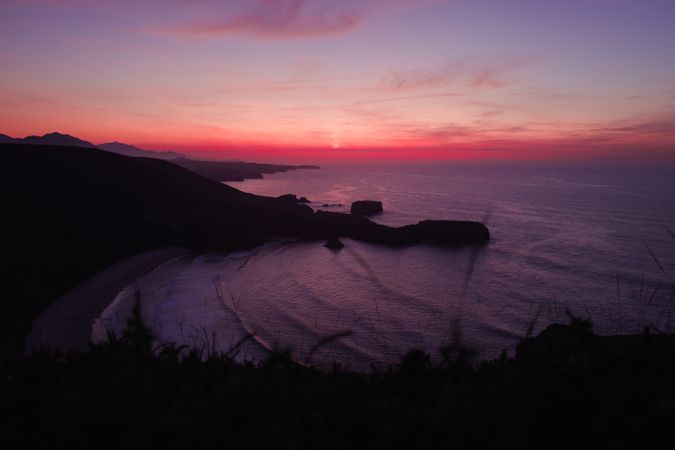 Sunset over picturesque hills and sea