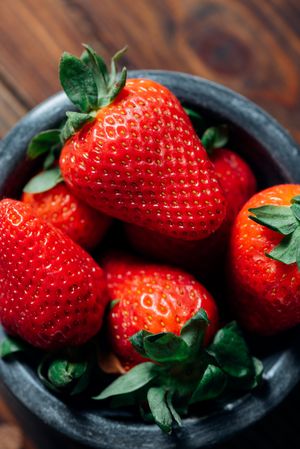 Fresh ripe strawberries in concrete bowl
