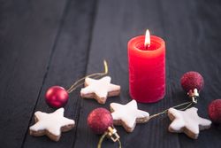 Red candle on wooden table and Xmas elements