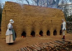 Two people at fire pits, Colonial Williamsburg, Virginia