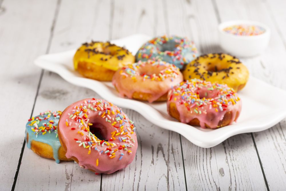 Delicious assorted colorful donuts on the table.