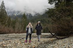 Two content women enjoying scenery on mountain hike