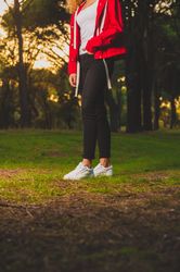Crop sportive woman standing on meadow