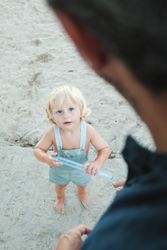 Toddler playing with toy at beach