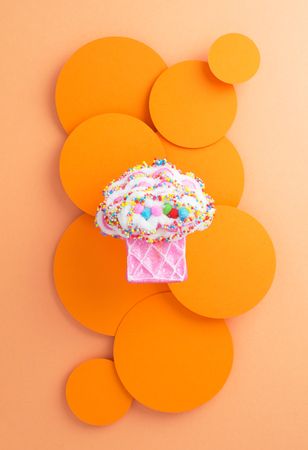Cute muffin toy on orange background