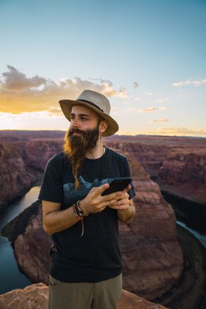 Traveler on the mobile phone near canyon