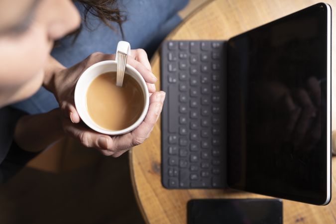 Young female using digital tablet in cafe