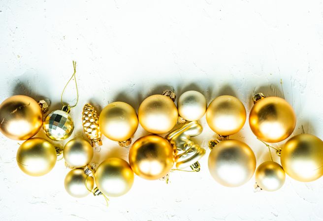 Top view of line of golden baubles on table
