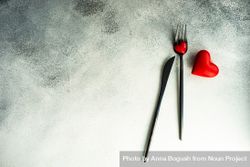 Cutlery on grey counter with red heart decorations 5nggOl