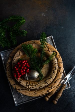 Top view of rustic plates with xmas pine and ornament