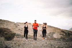 Multiracial friends jogging on nature together