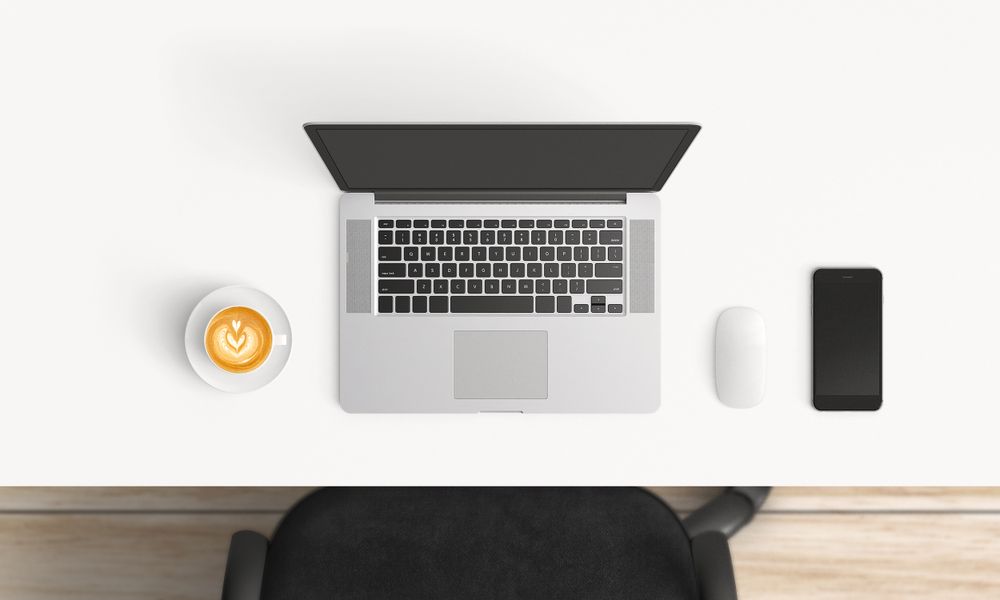 Modern workplace with laptop and smartphone copy space on table background. Top view. Flat lay style.